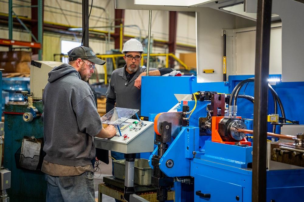 tube-fabricator-rebuilds-line-of-cutoff-machines-1677100837 Operator running Ringmaster tube cutting machine for continuous high-volume ring production